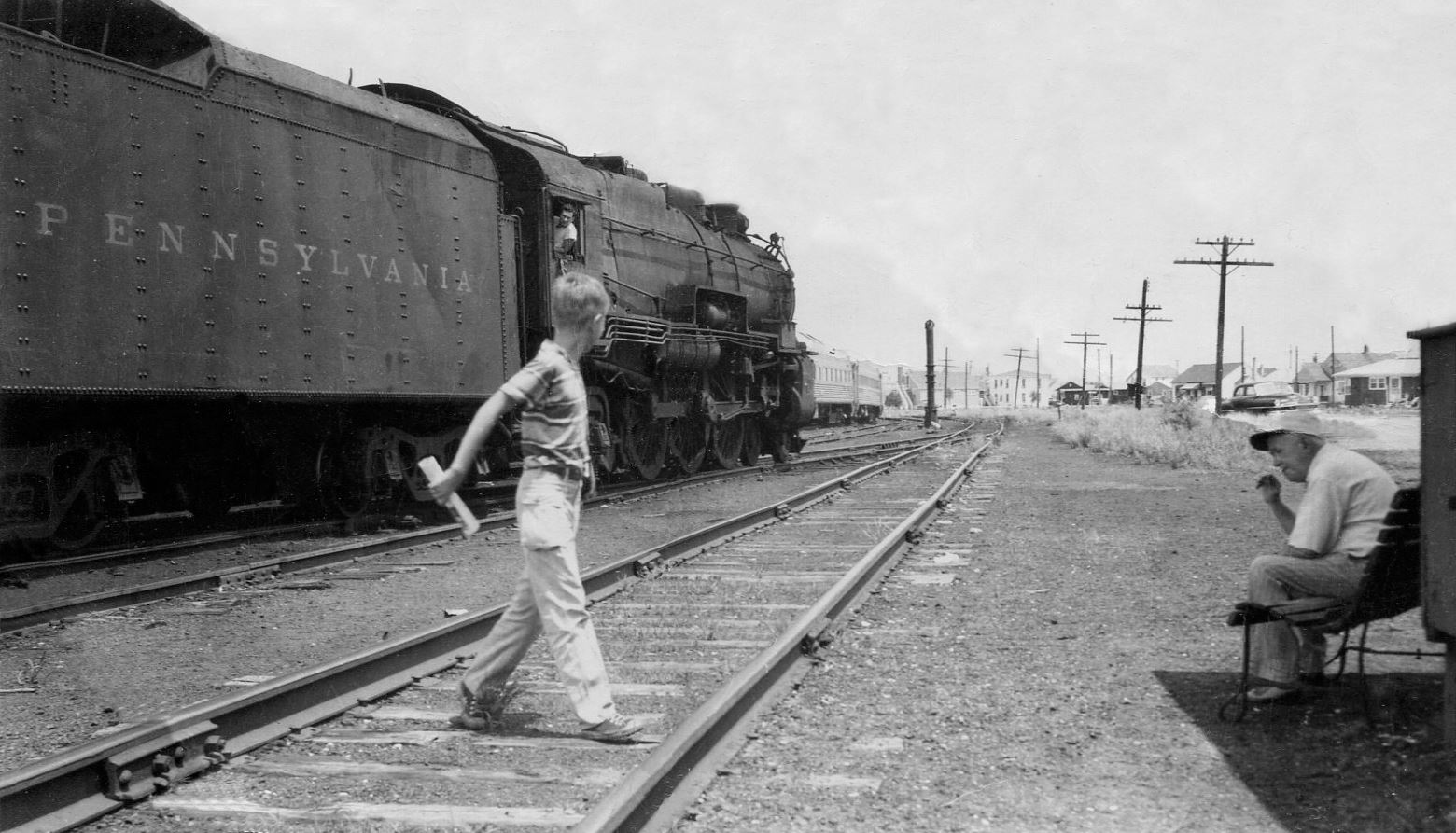 Photo from 1956 of a boy and a man next to a steam locomotive at the Cold Spring Freight Yard in Wildwood Crest, NJ