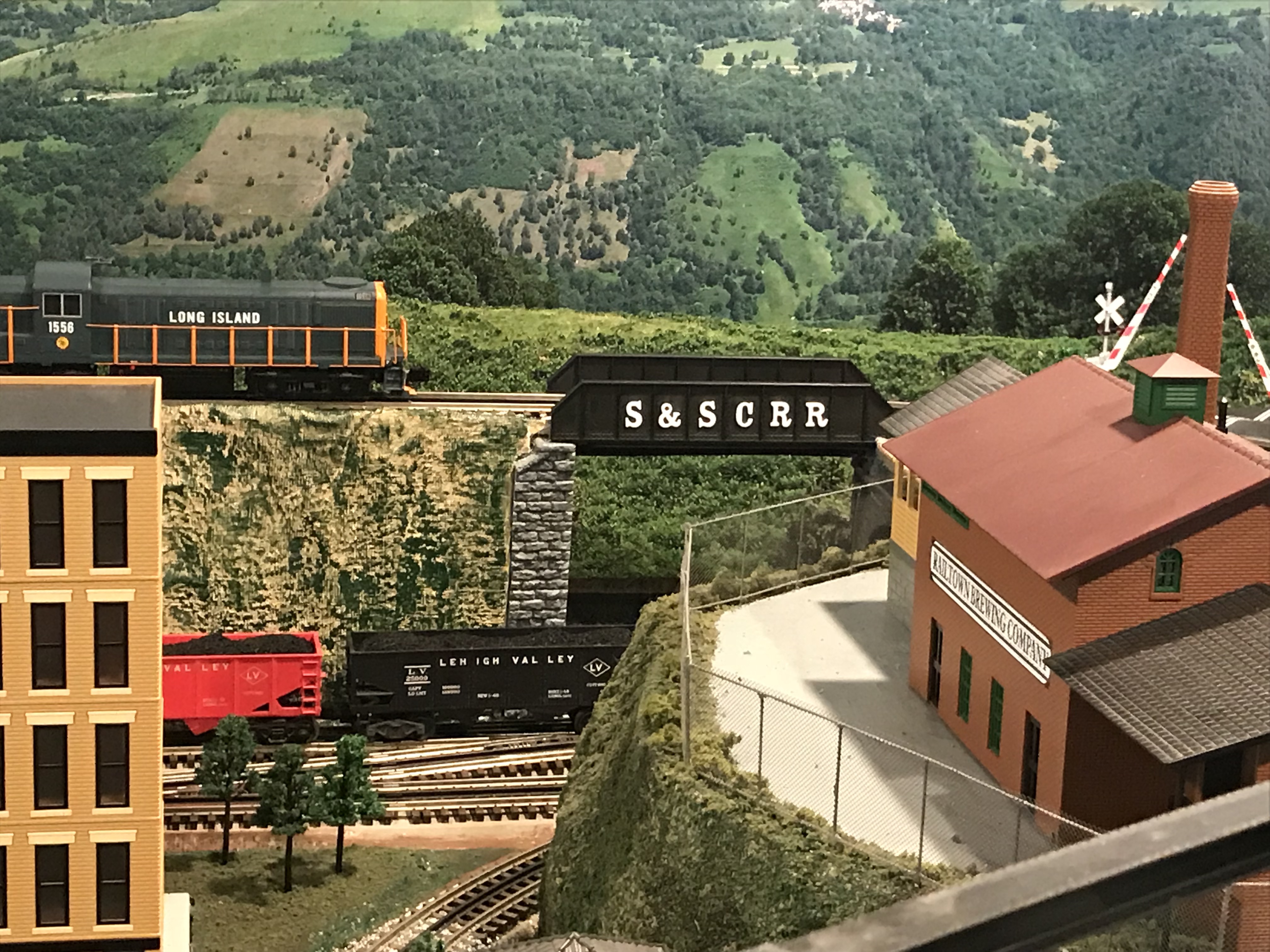 Layout photo with the Long Island RS3 Diesel about to cross a small girder bridge, marked S&SCRR (Sweetbriar and Southern Cape Railroad)