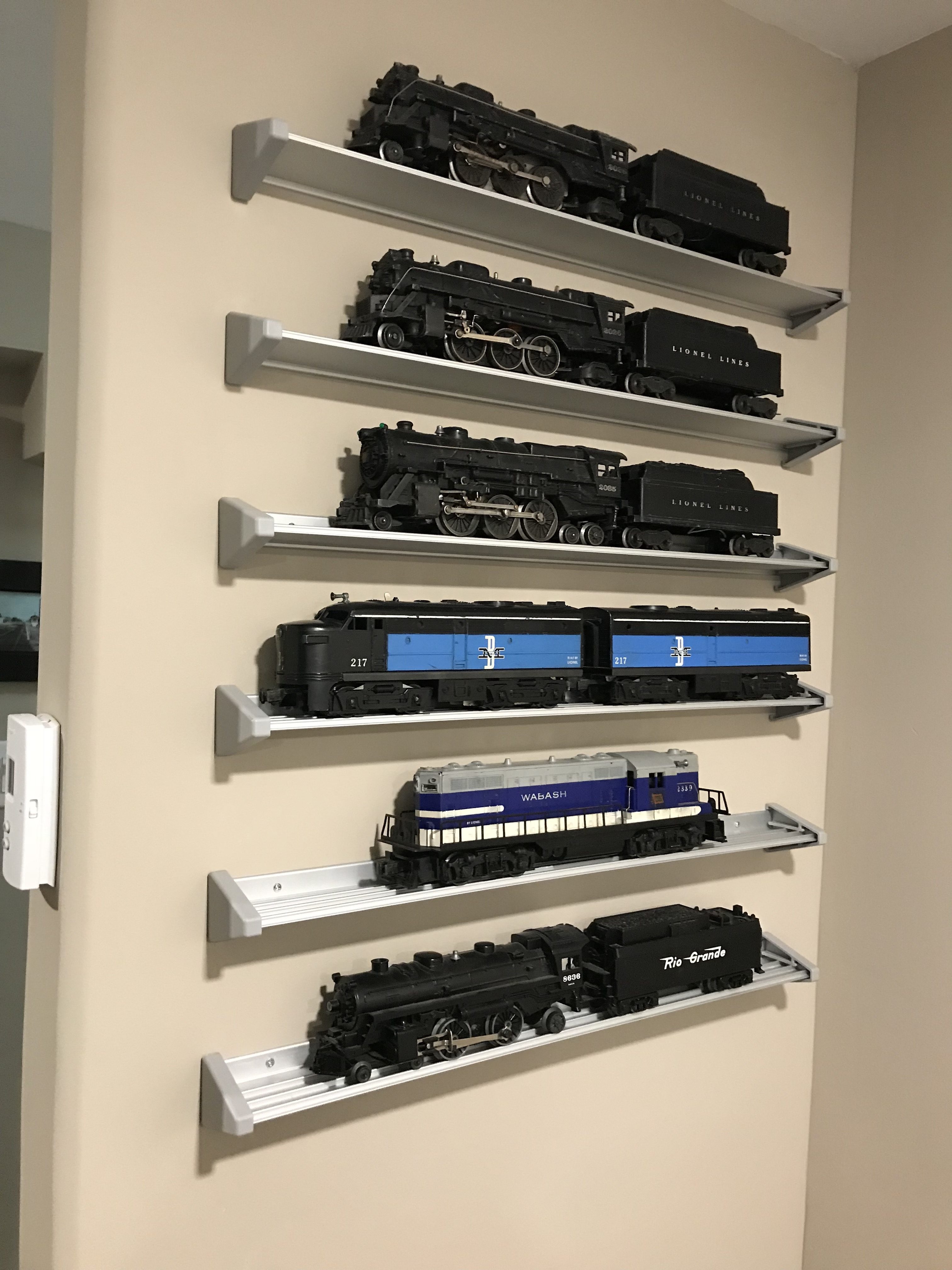My six vintage Lionel locomotives on shelves in a room adjacent to the layout